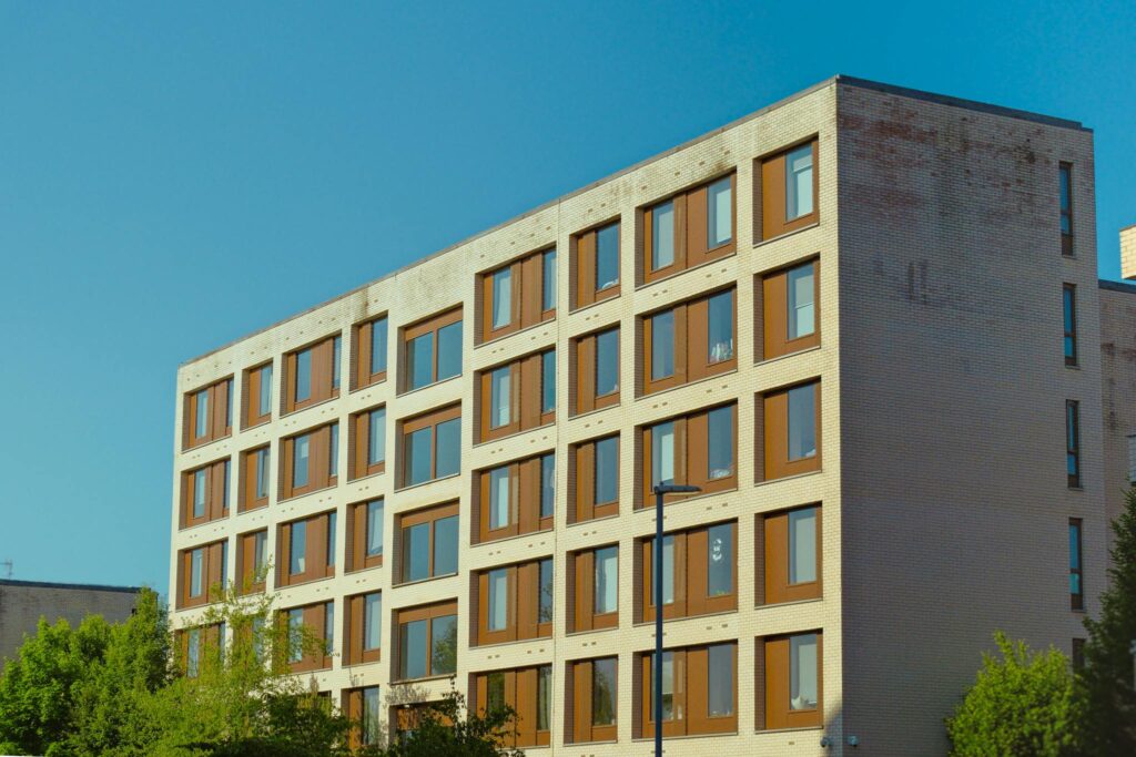 Contemporary brick apartment building against a clear blue sky.